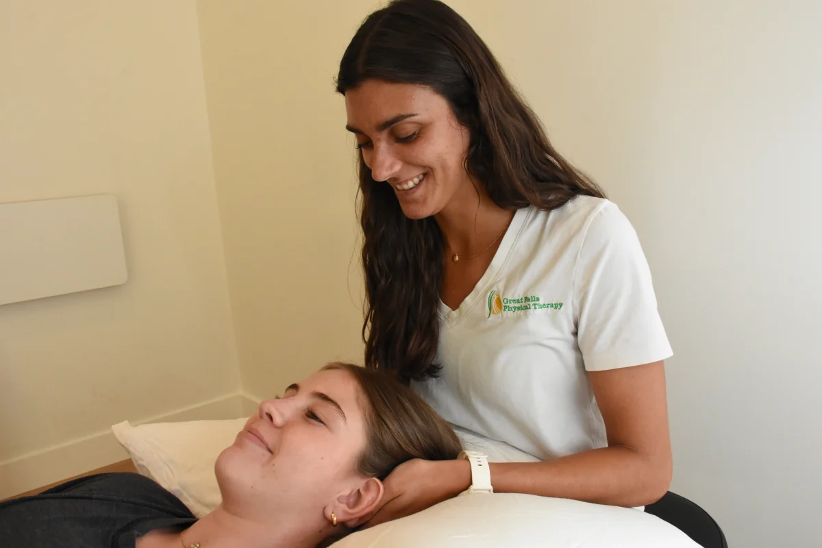 Dr. Kelsey Krause treating a patient's neck at Great Falls Physical Therapy