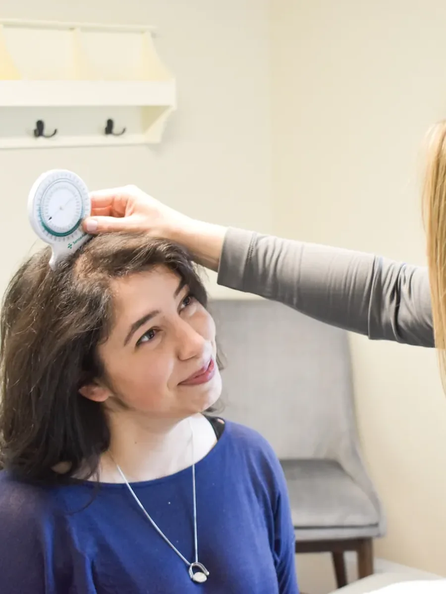 Physical therapist measuring a patient's cervical range of motion during an ergonomic assessment