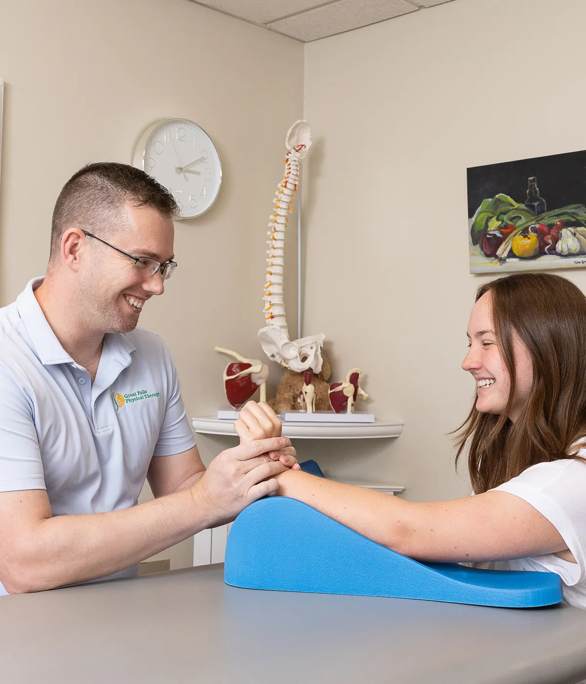 Hand therapist working with a patient on hand and wrist mobility at Great Falls Physical Therapy