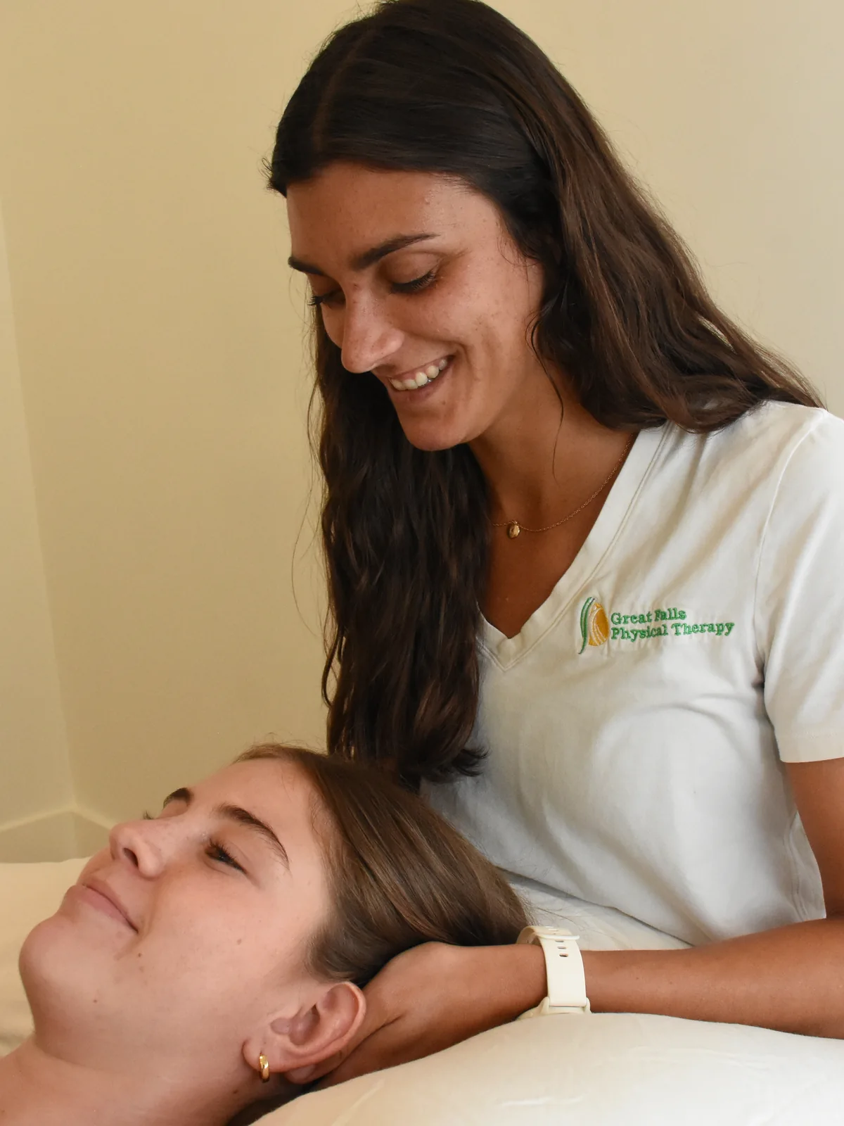 Physical therapist providing one-on-one care to a patient in a private treatment room