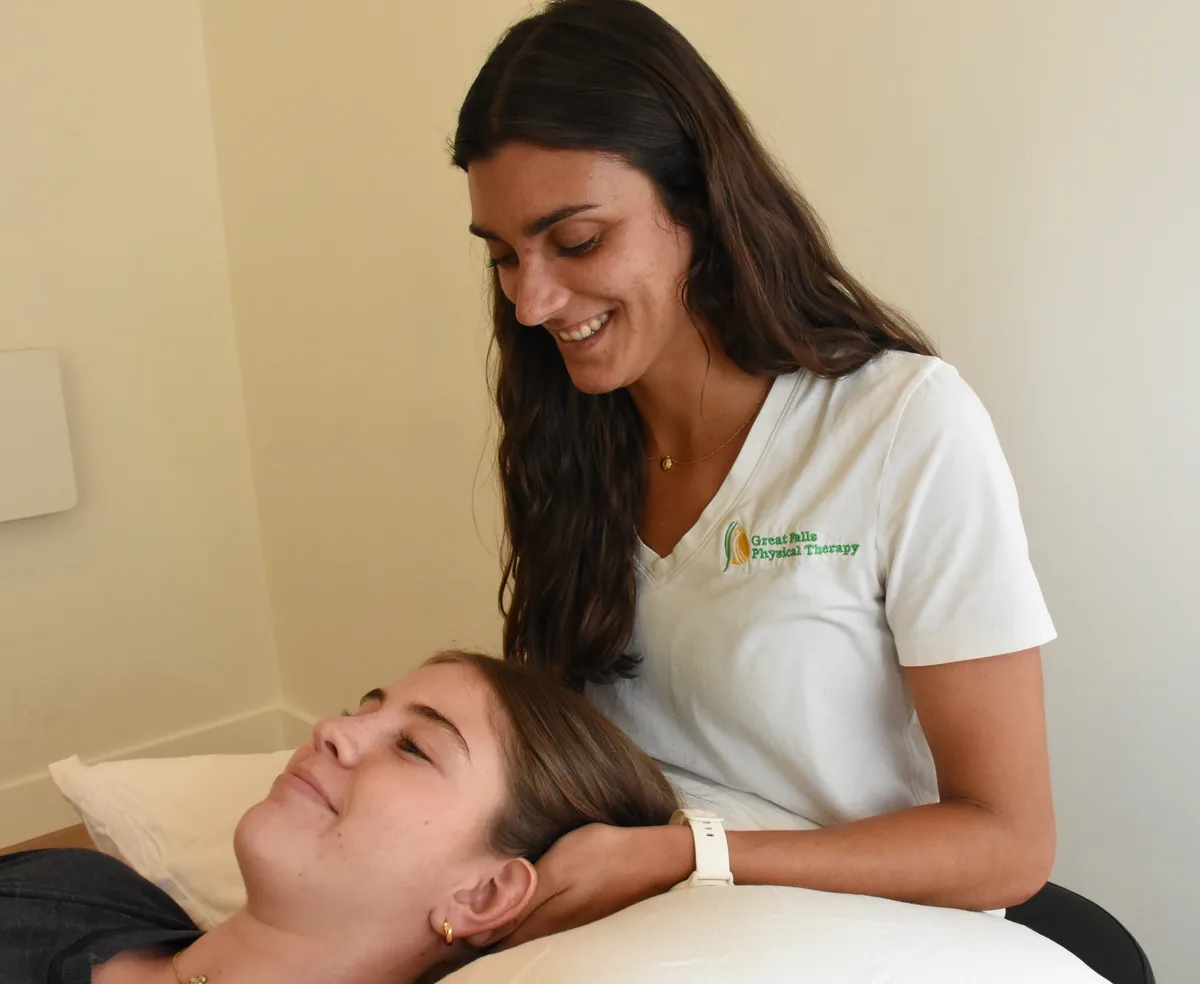Physical therapist providing one-on-one care to a patient in a private treatment room