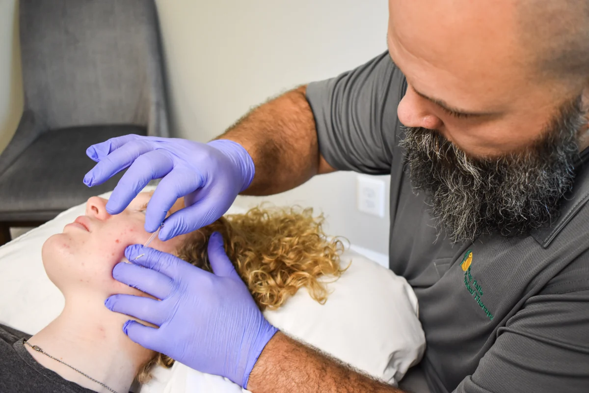 Dr. Jaison Alderman performing dry needling for jaw pain